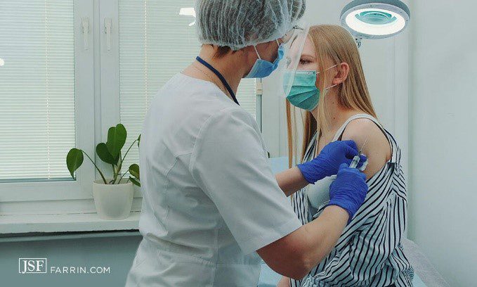 nurse administering a shot to a patient
